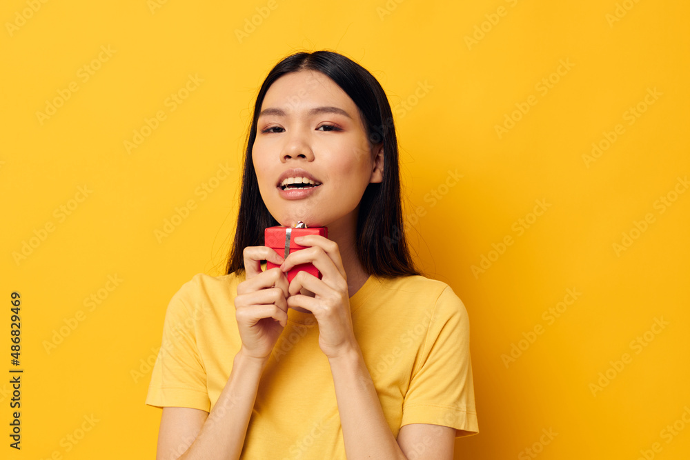 Charming young Asian woman holding a gift box in his hands posing Monochrome shot Charming young Asian woman holding a gift box in his hands posing Monochrome shot