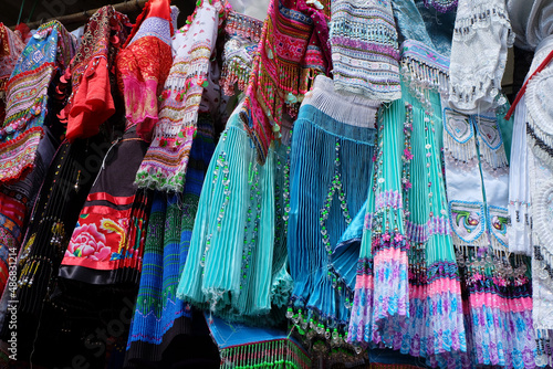 Close up photo of traditional skirts and dresses of Ethnic Minority, hanging to sell in Sapa Market, Vietnam © hippomyta