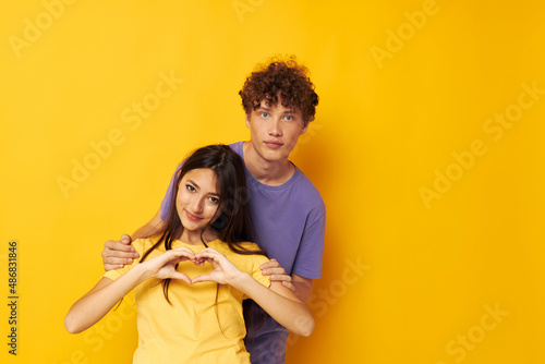 cute young couple Friendship posing fun studio yellow background unaltered