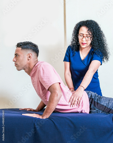 Lower back physiotherapy, physiotherapy treatment concept, physiotherapist with patient