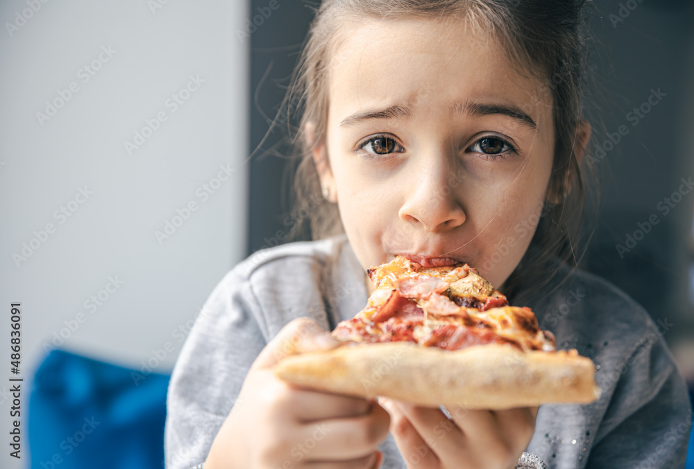 Portrait of a little girl with an appetizing piece of pizza. Portrait of a little girl with an appetizing piece of pizza.