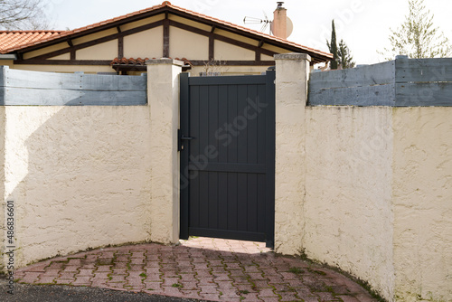 pedestrian entrance door in the garden of the house modern grey single home entrance in street city property real estate