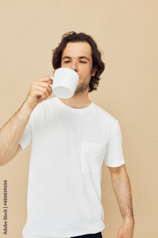 Cheerful man with a white mug in his hands emotions posing isolated background Cheerful man with a white mug in his hands emotions posing isolated background