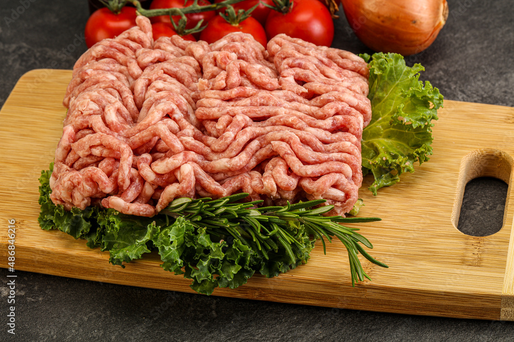 Raw pork minced meat over board Raw pork minced meat over board