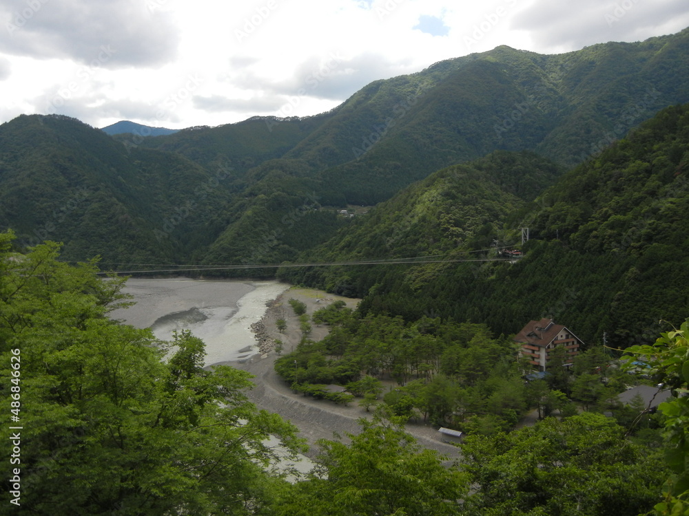 A scene of Taniseno-no-hashi Suspension Bridge in Totsugawa-mura Village in Yoshino County in Wakayama Prefecture in Japan 奈良県吉野郡十津川村にある日本最長の谷瀬の吊り橋 A scene of Taniseno-no-hashi Suspension Bridge in Totsugawa-mura Village in Yoshino County in Wakayama Prefecture in Japan 奈良県吉野郡十津川村にある日本最長の谷瀬の吊り橋