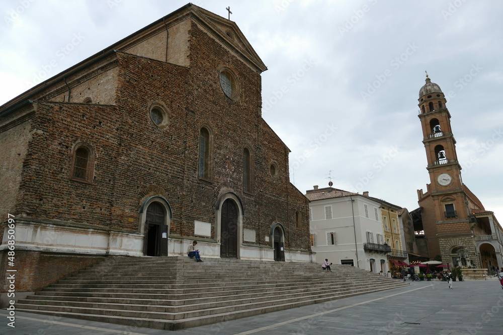 St. Peter Cathedral in Faenza, the facade unfinished built by rough brick, and with in front the staircase and the square
