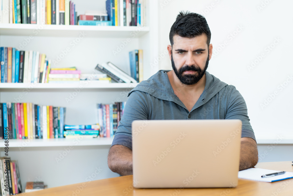 Latin american software programmer with hipster beard at work Latin american software programmer with hipster beard at work