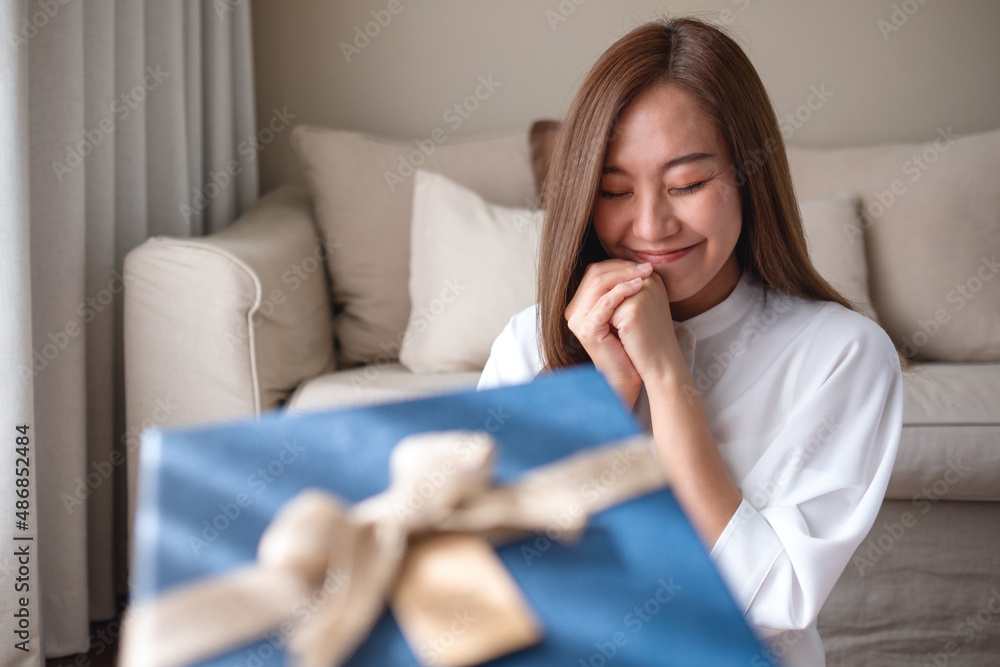 Portrait image of a surprised young woman receiving a gift box Portrait image of a surprised young woman receiving a gift box