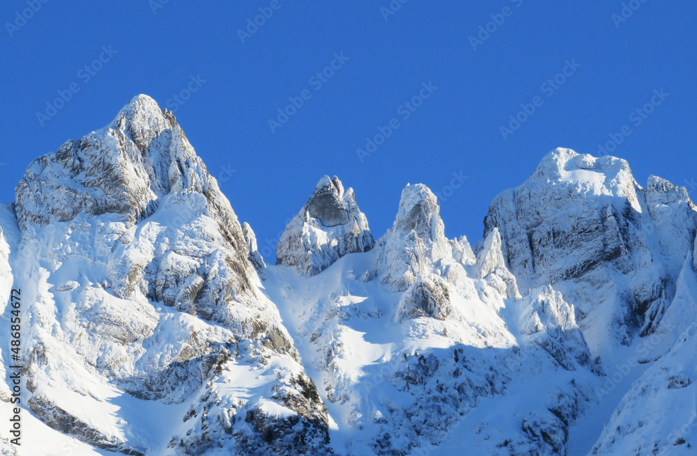 Obraz premium Winter ambience and beautiful idyllic atmosphere on the steep alpine rocky peak Schwarzchopf (1950 m.a.s.l.) and the mountain Alpstein - Appenzell Alps massif - Switzerland (Schweiz)
