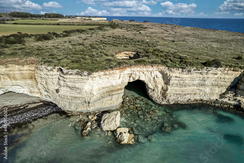 Coast of island of Otranto, Puglia, Salento, Italy. Turquoise sea, clear blue sky, rocks, sun, Tourist Apulia, Aerial View Sea photo