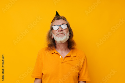 Portrait elderly man fun birthday cap on the head isolated background