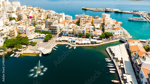 Agios Nikolaos. Agios Nikolaos is a picturesque town in the eastern part of the island Crete built on the northwest side of the peaceful bay of Mirabello.