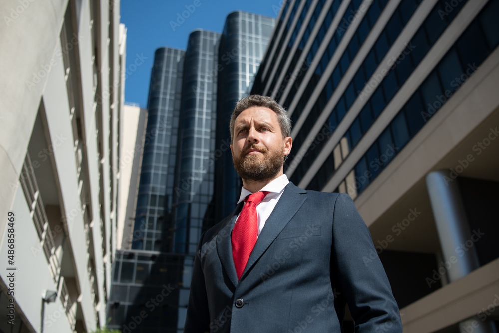 Portrait of businessman in front of modern office. Portrait of businessman in front of modern office.