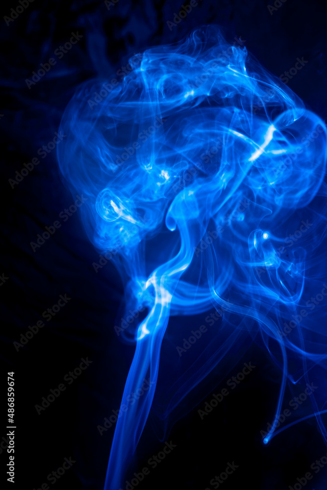 Fototapeta premium Blue smoke on black background.