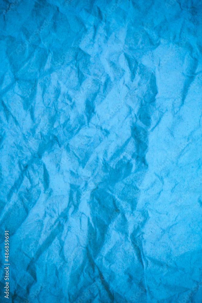 Obraz premium Blue crumpled paper background.
