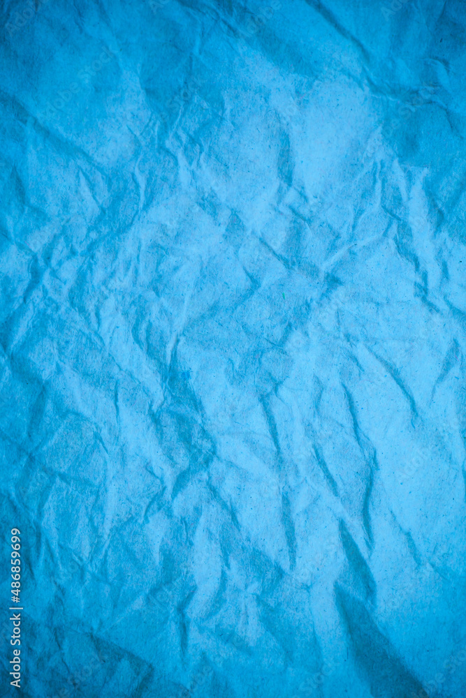 Obraz premium Blue crumpled paper background.