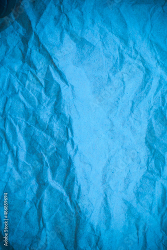 Blue crumpled paper background.