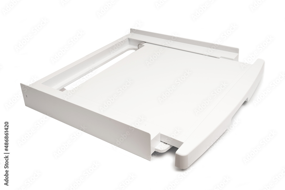 Shelf for joining into a column of a washing machine with a dryer on a white background. Accessory for washing machines. Retractable shelf. goods for bathroom and laundry. Shelf for joining into a column of a washing machine with a dryer on a white background. Accessory for washing machines. Retractable shelf. goods for bathroom and laundry.