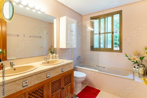 a view inside a bathroom with bath and double marble sink inside a villa in Marbella  