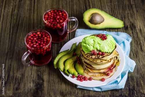 Pancakes with avocado ice cream. Avocado. Lingonberry juice.