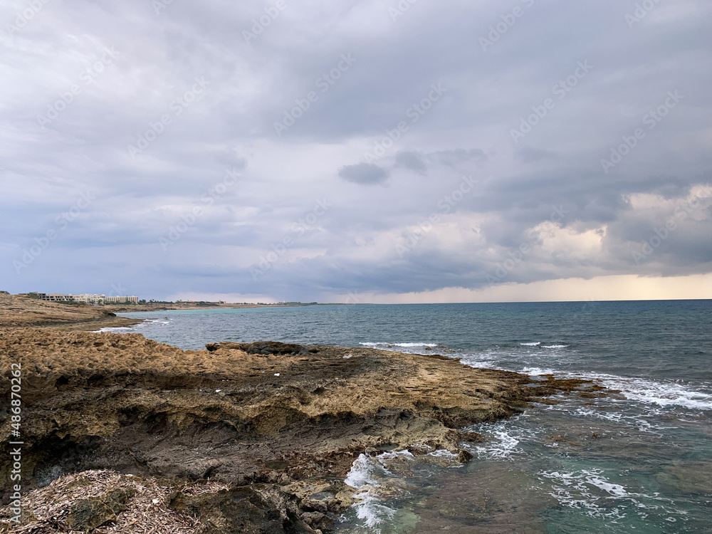 Dark clouds at the seascape, natural colors, rocky coastline