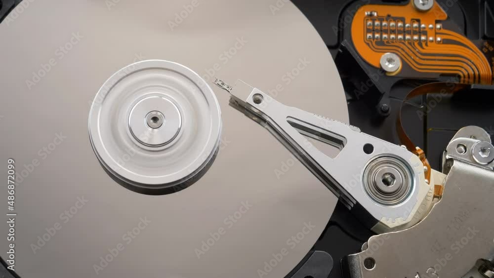 Hard disk drive with spinning platter. Working HDD reading head on the computer. Seamless loop, 10-bit depth Hard disk drive with spinning platter. Working HDD reading head on the computer. Seamless loop, 10-bit depth