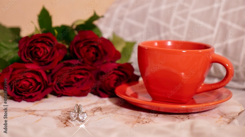 Background Festive Flatlay, composition for Valentine's Day on February 14. Coffee in a red cup, red rose flowers and diamond heart earrings Background Festive Flatlay, composition for Valentine's Day on February 14. Coffee in a red cup, red rose flowers and diamond heart earrings