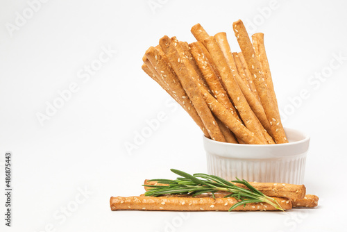 Tableau sur toile Classic crispy Italian bread sticks with rosemary and sesame seeds in white form