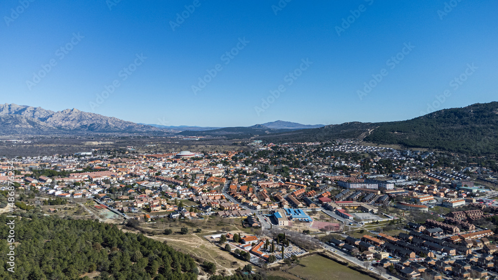 Aerial view of the well known village of Moralzarzal, next to beautiful pine forests, located in the mountainous area northwest of Madrid, Spain.