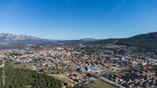 Aerial view of the well known village of Moralzarzal, next to beautiful pine forests, located in the mountainous area northwest of Madrid, Spain.
