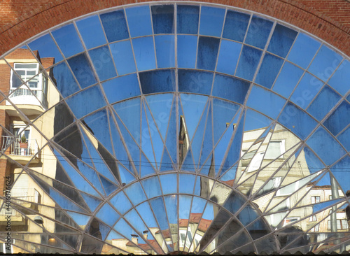 Deformed reflection on the market facade. Historic city center of Zamora. Spain.