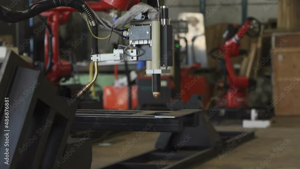 Welding robots movement in a car factory, automotive parts industry. Welding robots movement in a car factory, automotive parts industry.