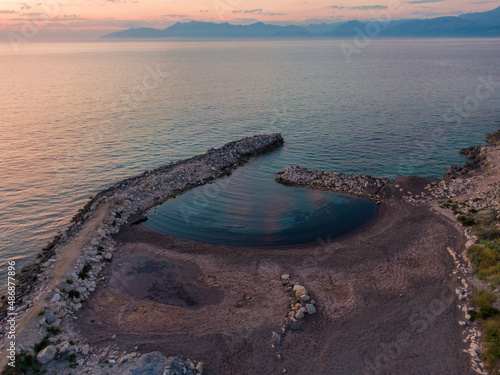 Aerial drone view of almyros beach in sunset  kerkyra greece photo