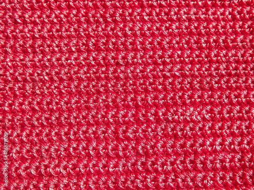 Knitted fabric of pink, crimson color close-up as a background. High quality photo