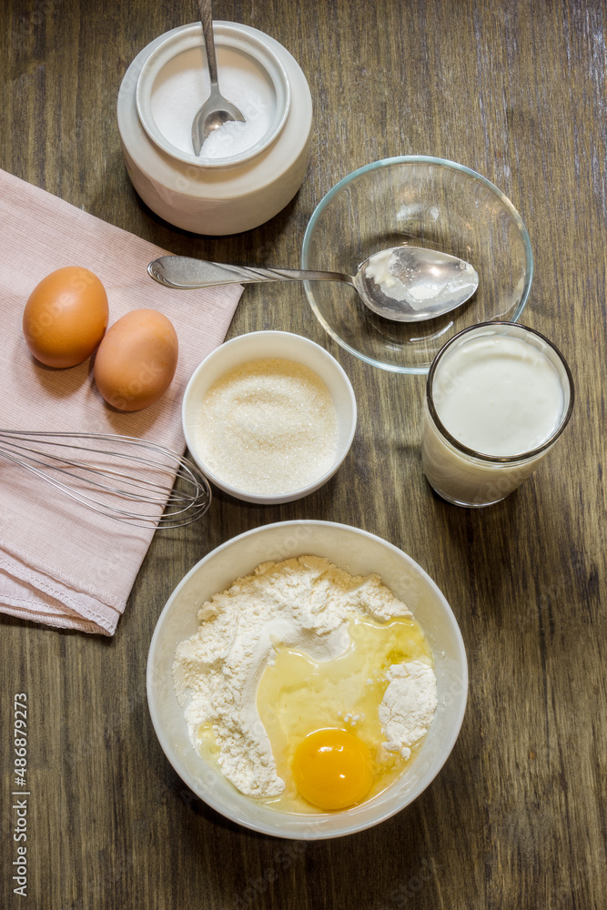 Dough for cooking pancakes on kefir. Eggs, flour, a glass of kefir, sugar, salt. Country style. Dough for cooking pancakes on kefir. Eggs, flour, a glass of kefir, sugar, salt. Country style.