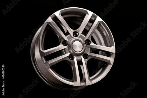alloy wheel, shiny with gray on black background close-up