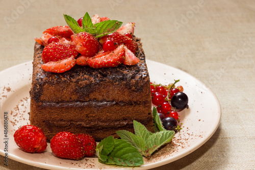 Homemade baking. Chocolate cake with strawberries and mint.