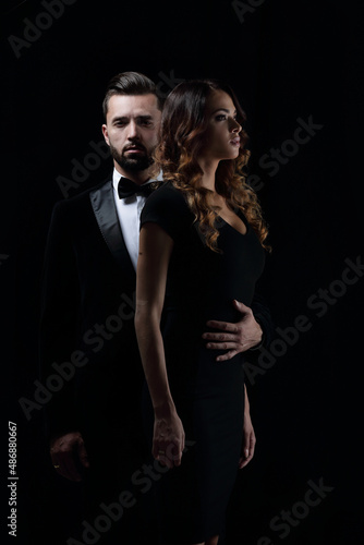 photo of young family couple on black background.