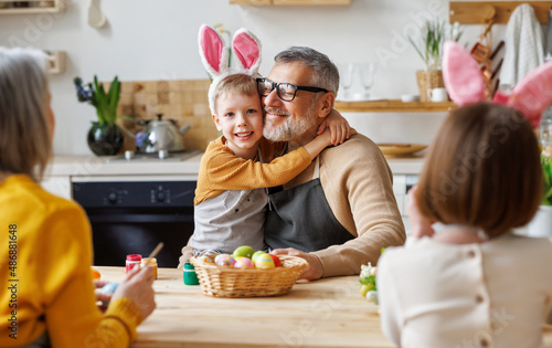 Wall Mural Happy family grandfather and little grandson holding wicker basket full of paint