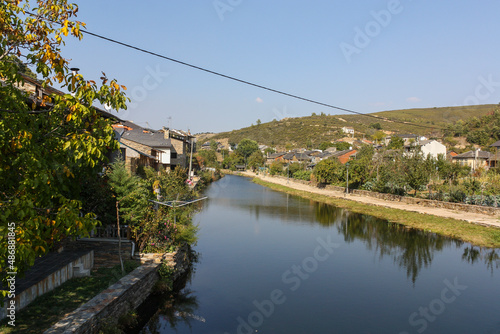 River near the houses in Rihonor de Castilla, Spain photo