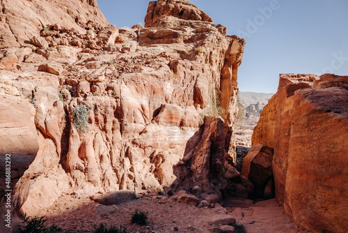 Ruins of the ancient city of Petra in Jordan. Red sandstone mountains on a clear day. Caves in the rock. Landscape. Colorful photos.