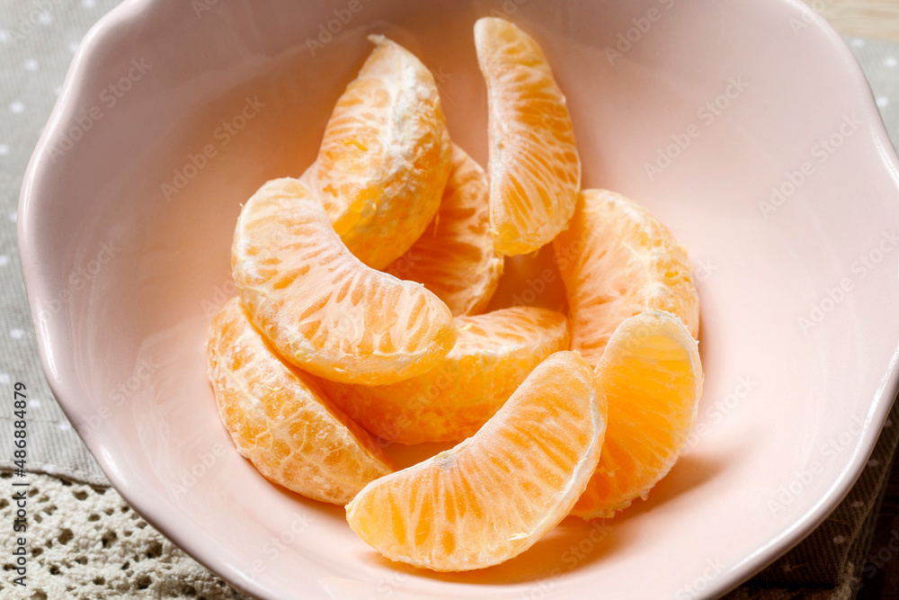 A pieces of tangerine in a bowl. A pieces of tangerine in a bowl.