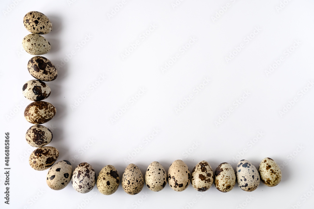 frame of quail eggs on the perimeter of two sides on a white background. Copy space. frame of quail eggs on the perimeter of two sides on a white background. Copy space.
