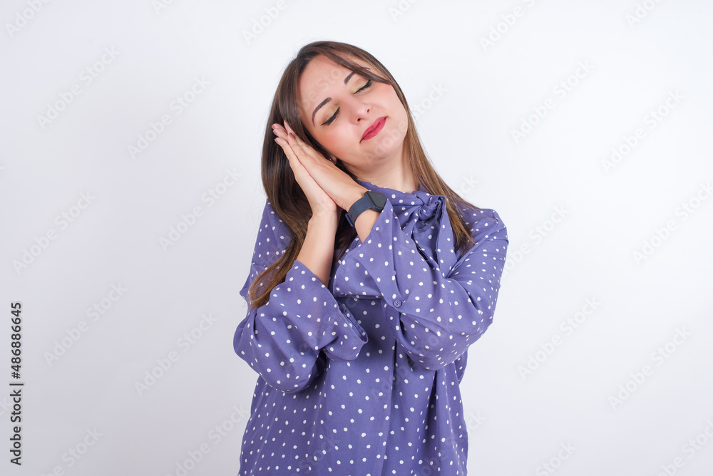 Relax and sleep time. Tired MODEL with closed eyes leaning on palms making sleeping gesture. Relax and sleep time. Tired MODEL with closed eyes leaning on palms making sleeping gesture.