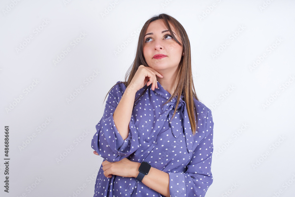 Face expressions and emotions. Thoughtful MODEL holding hand under his head, having doubtful look. Face expressions and emotions. Thoughtful MODEL holding hand under his head, having doubtful look.