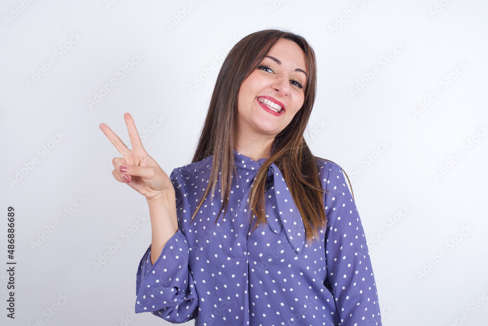 Profile of smiling Young arab woman wearing polka-dot clothes over white backgtound with healthy skin, has contemplative expression, ready to have outdoor walk. Profile of smiling Young arab woman wearing polka-dot clothes over white backgtound with healthy skin, has contemplative expression, ready to have outdoor walk.