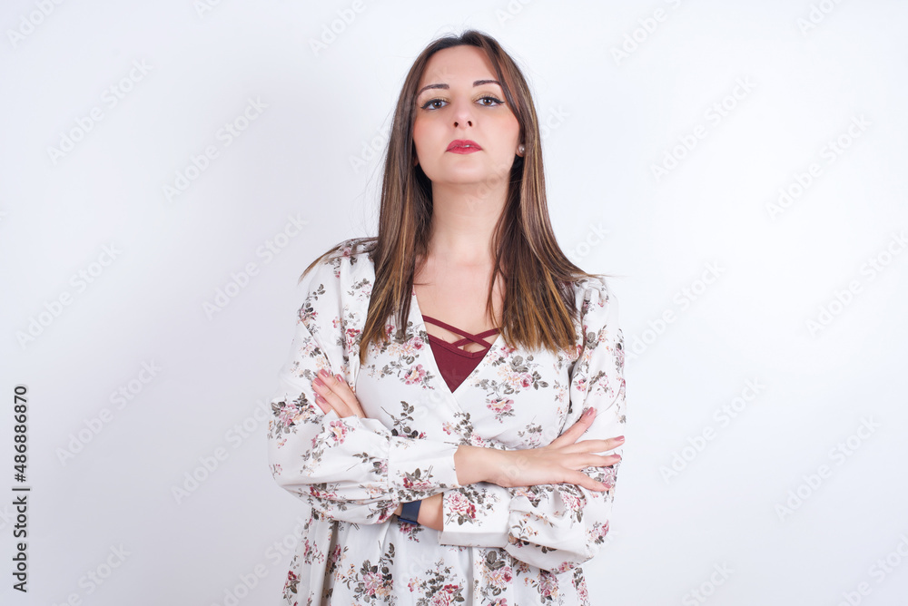 Picture of angry Young arab woman wearing floral shirt over white backgtound looking camera. Picture of angry Young arab woman wearing floral shirt over white backgtound looking camera.