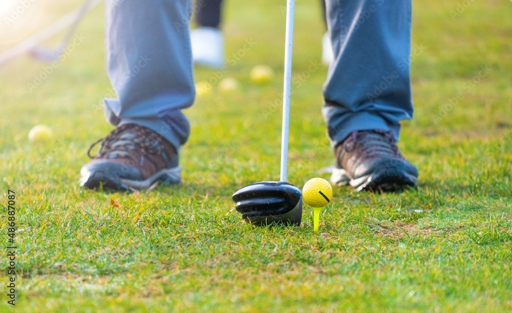 Man practicing swing on a green golf course. golf training Man practicing swing on a green golf course. golf training
