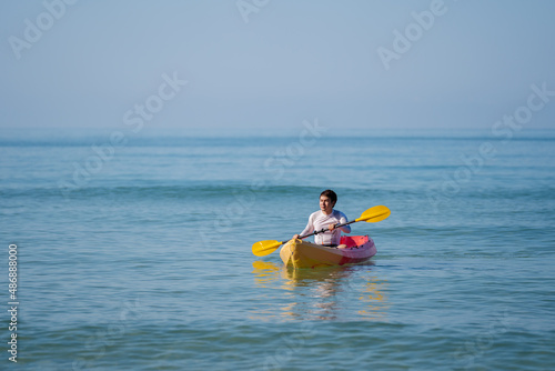 man paddling a kayak boat in sea © geargodz