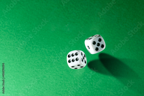 Dice  shot from above  on a green background with copy space.